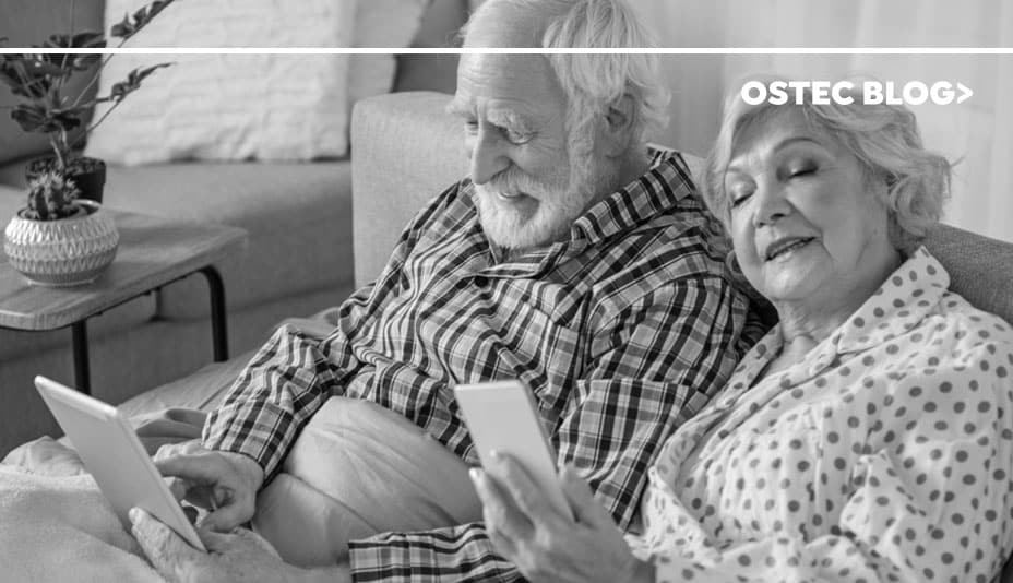 elderly couple using electronic devices